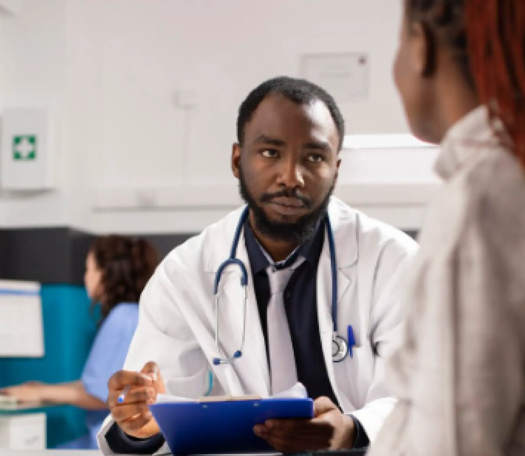 Doctor reviewing notes with a patient